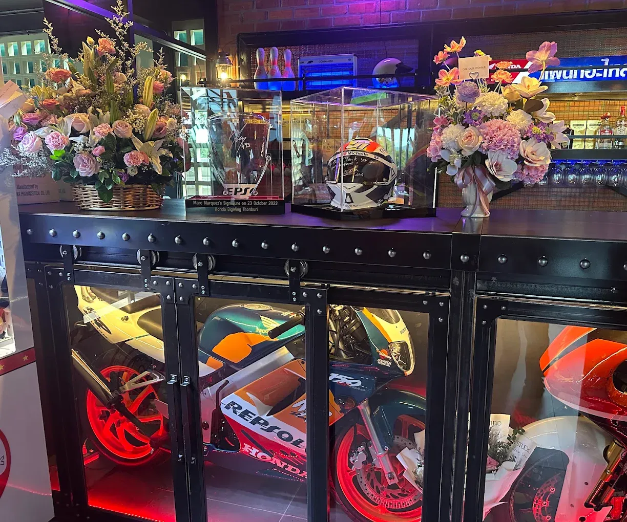 The museum bar at Box Box, trophy display behind the counter