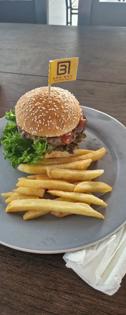 The BOX BOX burger and fries, flying the brand flag