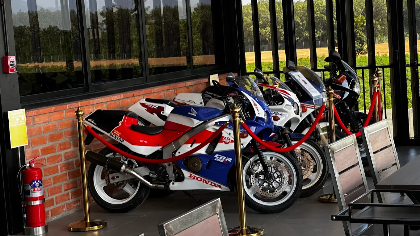 A lineup of classic Honda CBR motorcycles displayed along the restaurant walkway
