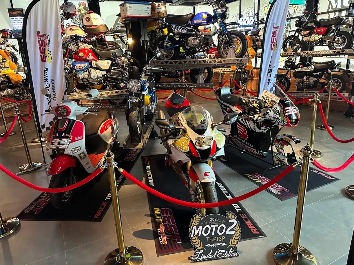 Racing machines behind red ropes on the Motorbike Gallery floor