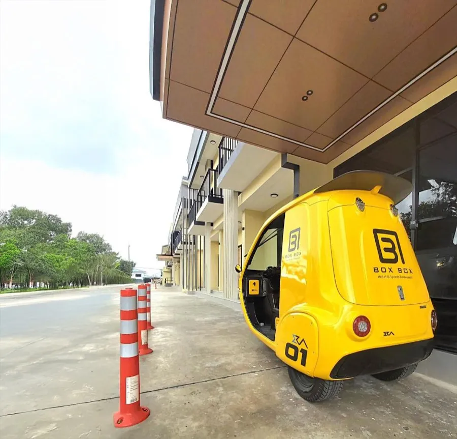 The BOX BOX electric shuttle under the entrance canopy